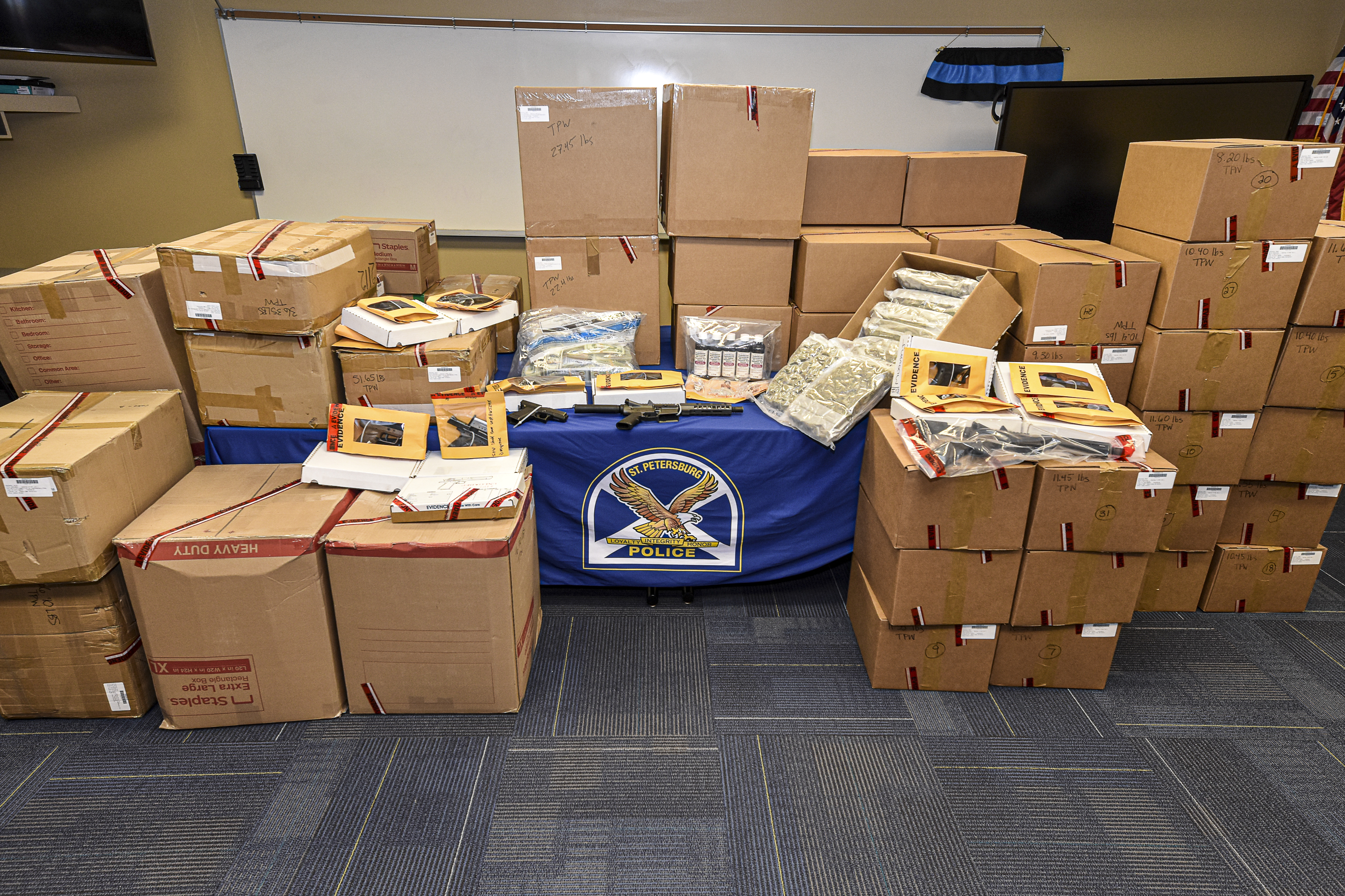 Boxes of drugs, cash and evidence from drug bust