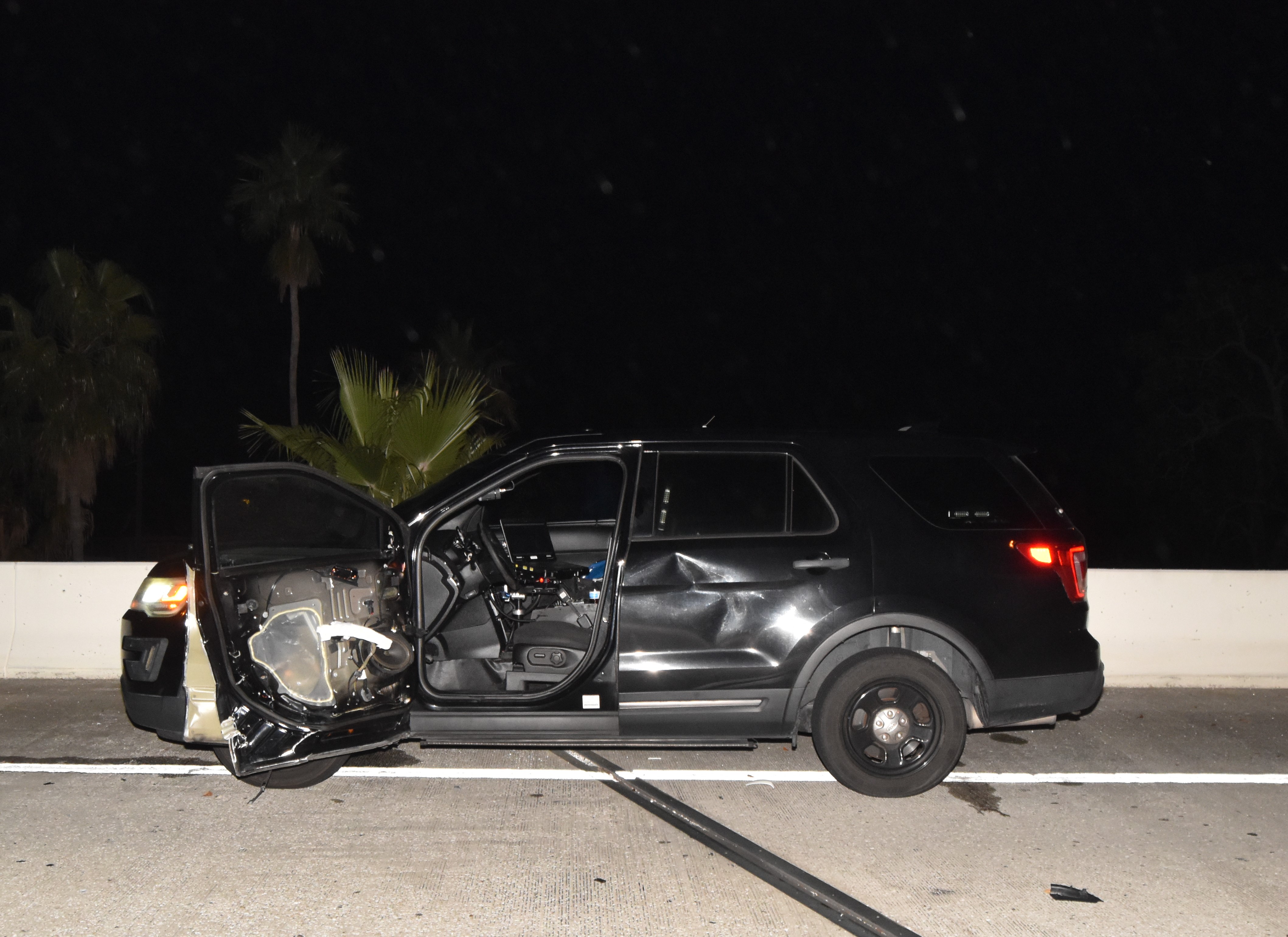 black police suv with damage to driver door and back passenger door